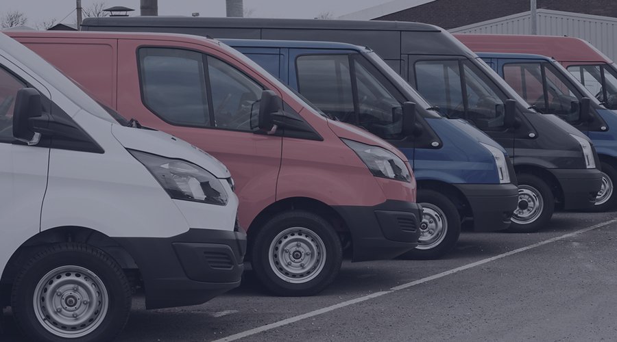 Multicoloured vans parked on a slant